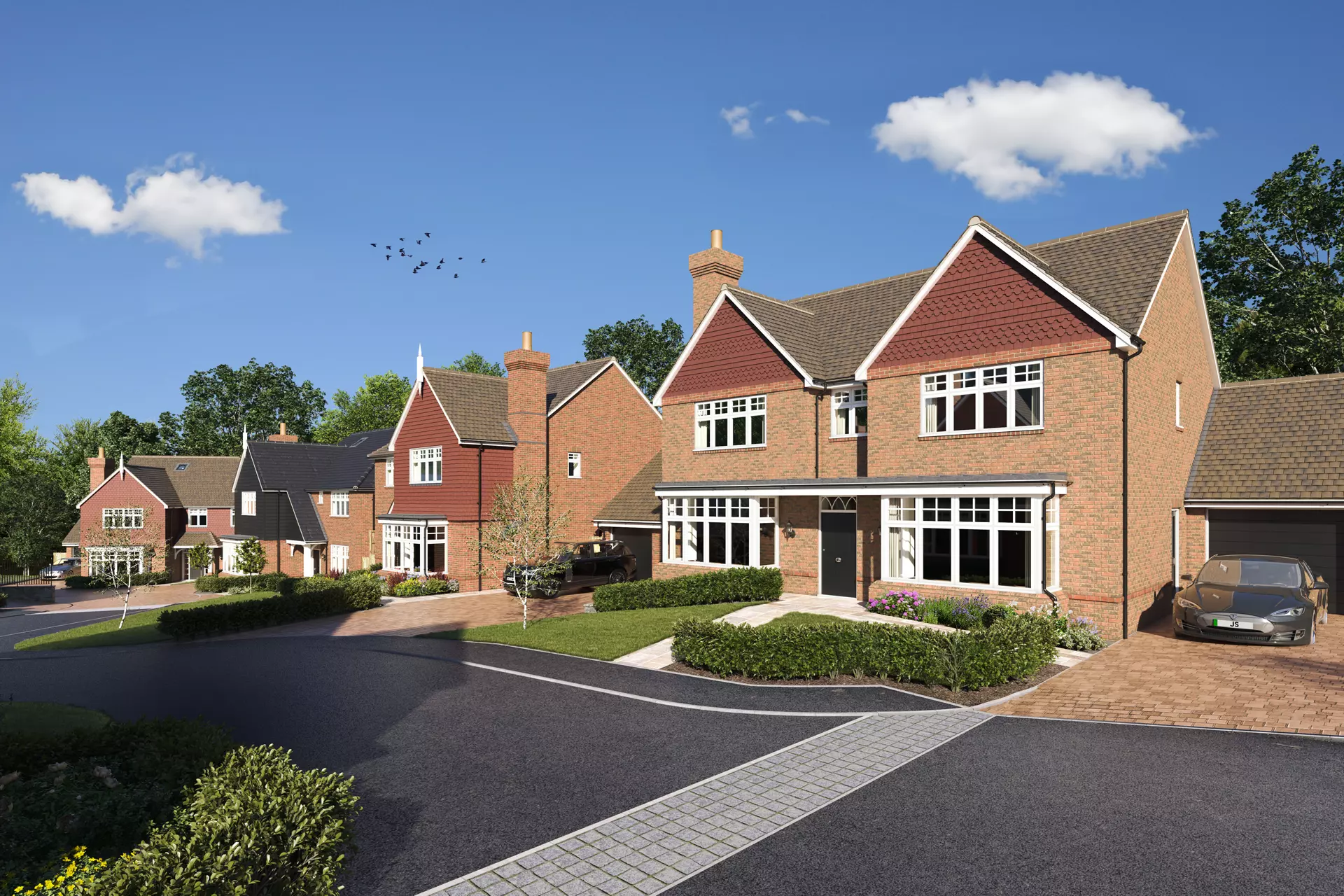 New suburban houses with well-kept lawns under a clear blue sky.